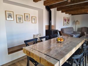 a living room with a wooden table and chairs at La Palmera Casa Rural in L'Aldea