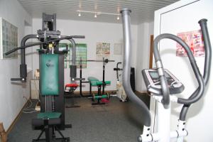 a gym with several tread machines in a room at Landgasthof Rieger in Dangenstorf