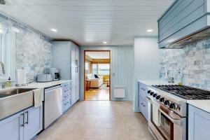 a kitchen with white cabinets and a stove top oven at Island House in Hancock