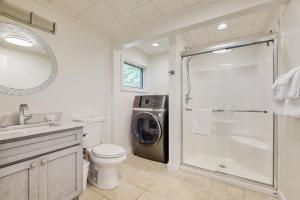 a bathroom with a shower and a washing machine at Island House in Hancock +25 photos