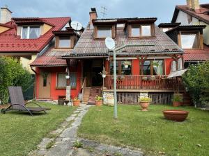 a house with a mirror in front of it at Privát Mulík in Stará Lesná