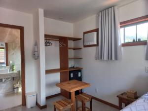 a room with a table and a sink in a room at Encanto da Serra Suítes Lumiar in Lumiar
