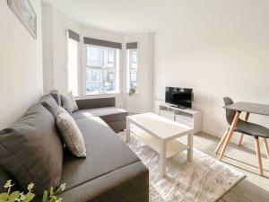 a living room with a couch and a table at Wellington Road Apartment 1 in Southtown