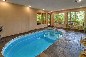 a large blue pool in a room with a deck at Mountain View, Indoor Pool, Luxury Cabin, Bears in Gatlinburg