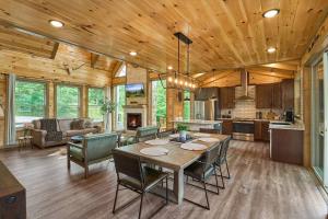 a kitchen and living room with a table and chairs at Mountain View, Indoor Pool, Luxury Cabin, Bears in Gatlinburg +50 photos