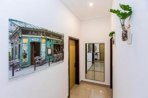 ein Flur mit einem Gemälde einer Straßenbahn in der Unterkunft Charmant appartement 2ch près de la plage in Pointe-Noire