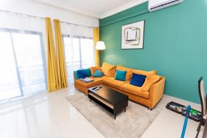 ein Wohnzimmer mit Sofa und Tisch in der Unterkunft Charmant appartement 2ch près de la plage in Pointe-Noire