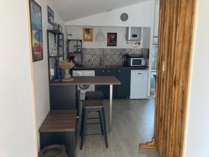 a small kitchen with a table and a counter at Ti Chai in Dolus-d'Oléron