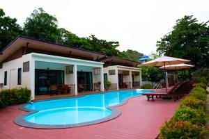 a swimming pool in front of a house at JP Resort Koh Tao in Ko Tao