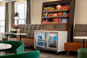 a drink cooler in a room with a couch at Hampton Inn by Hilton Boston/Cambridge in Cambridge
