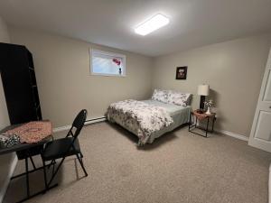 a bedroom with a bed and a table and chairs at Green House in St. John's