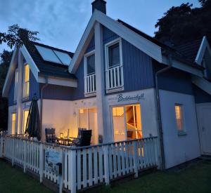 a house with a white fence in front of it at Breeger Boddenidyll in Breege