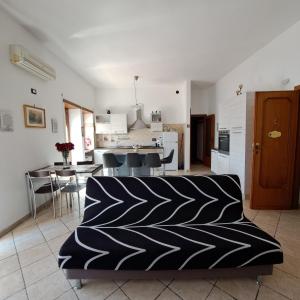 a living room with a couch and a kitchen at La Casa di Ale 2 - ampio e luminoso appartamento ai Castelli Romani in Marino +31 photos