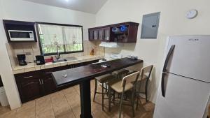a kitchen with a counter and a refrigerator at Sweet Dreams #4 in Coco