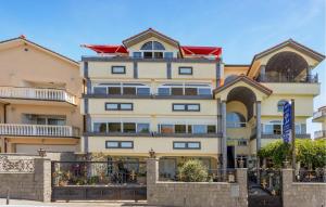 a large yellow building with a red roof at 4 Bedroom Awesome Apartment In Selce in Selce +31 photos