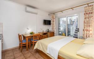 a bedroom with a bed and a table and a desk at 4 Bedroom Awesome Apartment In Selce in Selce