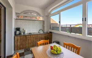 a kitchen with a table with a bowl of fruit on it at 4 Bedroom Awesome Apartment In Selce in Selce