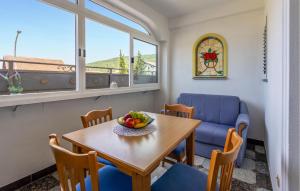a dining room with a table and a blue couch at 4 Bedroom Awesome Apartment In Selce in Selce