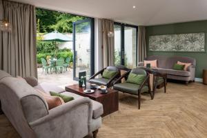 a living room with couches and chairs and a table at Lydiard Park Hotel in Swindon