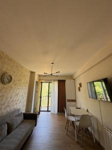 a living room with a couch and a table at Svani in Borjomi