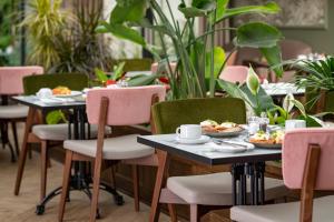 a restaurant with tables and chairs with food on them at Lydiard Park Hotel in Swindon +6 photos