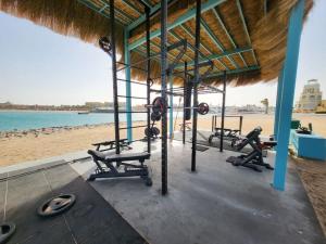 a gym with several treadmills and machines on the beach at Luxurious private Getaway in Mangroovy in Hurghada