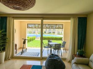 a living room with a sliding glass door to a patio at Luxurious private Getaway in Mangroovy in Hurghada