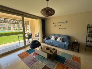 a living room with a blue couch and a table at Luxurious private Getaway in Mangroovy in Hurghada +52 photos