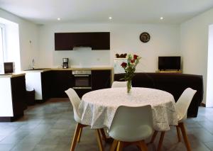 a living room with a table with a vase of flowers on it at Gite l'Eclat de Marcelle in Tournus