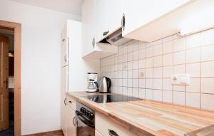 a kitchen with a sink and a stove at Ferienwohnung Mit Balkon in Hopfgarten im Brixental