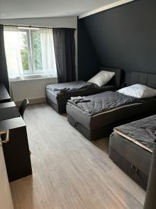 a room with three beds and a couch at Apartment Ferienwohnung Monteurwohnung Ecke in Magdeburg