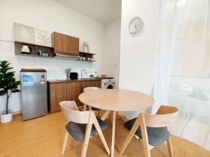 a kitchen with a table and chairs in a room at LV8 MintyMeadow 1-5pax Kuantan in Kuantan