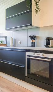 a kitchen with a black oven and cabinets at Kurzzeitglück 24h Self Check-In WI02 in Willich +20 photos