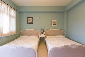 מיטה או מיטות בחדר ב-Wei Sen House