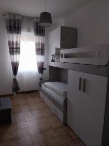 a room with a window and a shelf with a couch at Casa vacanze l'orchidea in Lecce +6 photos