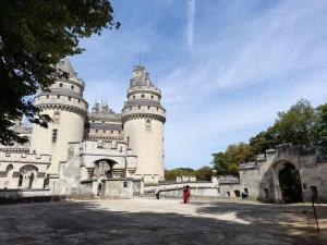 a castle with a person standing in front of it at Maison cosy avec jacuzzi in Thourotte