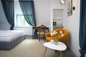 a bedroom with a bed and a chair and a table at Spichlerz na Krakowskiej in Kazimierz Dolny +66 photos