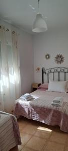 a bedroom with a bed with purple sheets and a lamp at Casa Rural Fuente del Céfano in Arroyo Frio +9 photos