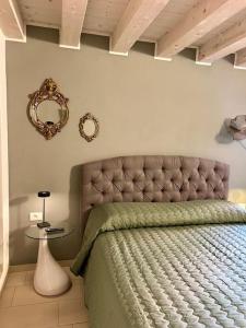 Un dormitorio con una cama y un espejo en la pared. en Elena s Home piano primo, en Chioggia
