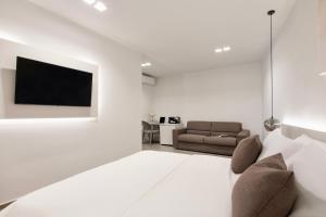 a living room with a couch and a tv at Cali Suites Mergellina in Naples +30 photos