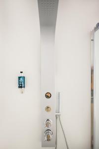 a white refrigerator with buttons on a wall at Cali Suites Mergellina in Naples