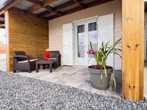 a porch with a potted plant on a house at L'enclos du volcan in La Plaine des Cafres