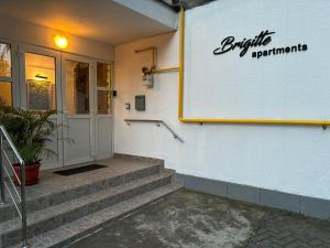 a building with a sign on the side of it at Brigitte Apartments in Sovata