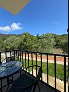 a patio with a table and chairs on a balcony at Svani in Borjomi