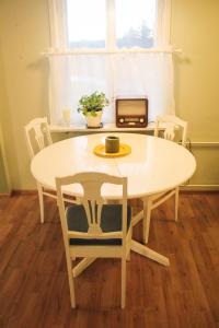a table and chairs with a table and a window at Poutapilvi in Bollstad +1 photo
