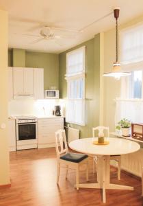 a kitchen with a table and chairs in a room at Poutapilvi in Bollstad