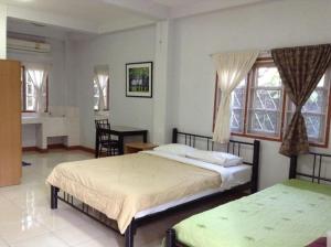 מיטה או מיטות בחדר ב-Pikul Apartment Hotel