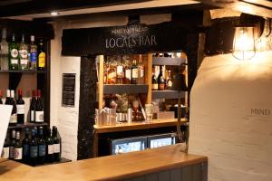 a bar with a lot of bottles of wine at The Chestnut Horse in Winchester