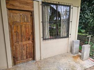 a wooden door with a gate on a house at Departamento Económico, Familiar in San Isidro +8 photos