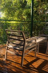 a wooden bench sitting on top of a wooden deck at Iguazu Jungle Lodge in Puerto Iguazú
